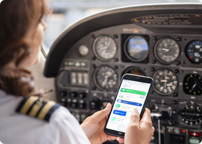 Pilot using the FlightApp mobile app above the instrument panel
